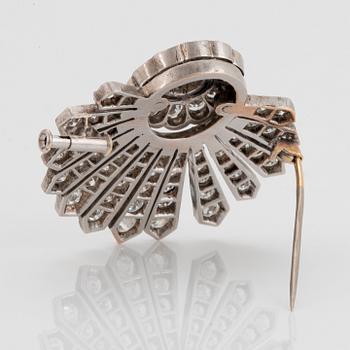 A 14K gold brooch set with round brilliant- and old-cut diamonds.