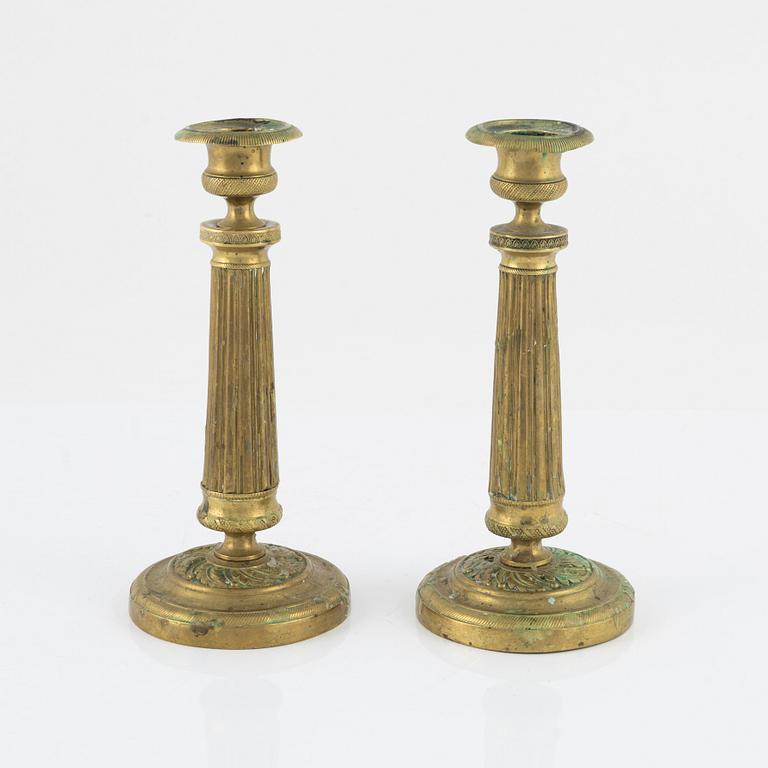 A pair of Empire bronze candlesticks, first half of the 19th Century.