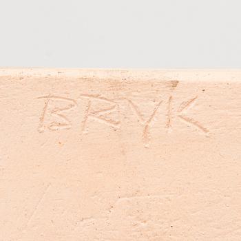 A stoneware relief signed BRYK.