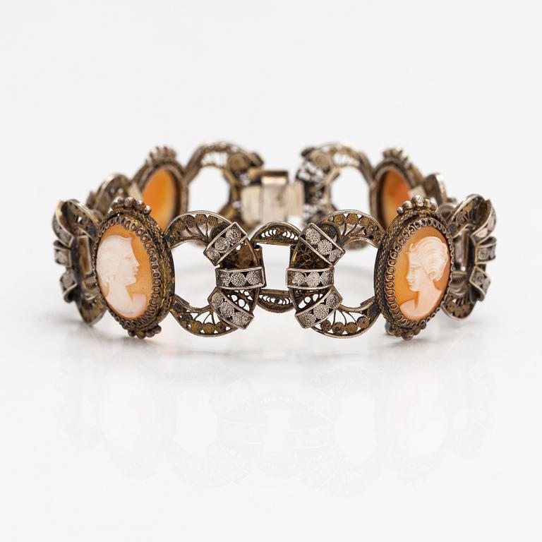 A silver and sea shell cameo bracelet.