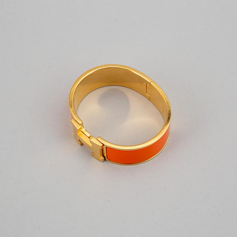 HERMÈS, a 'Clic H' bangle.