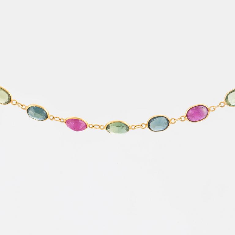 A necklace set with oval, mixed-cut, multi-coloured gemstones.