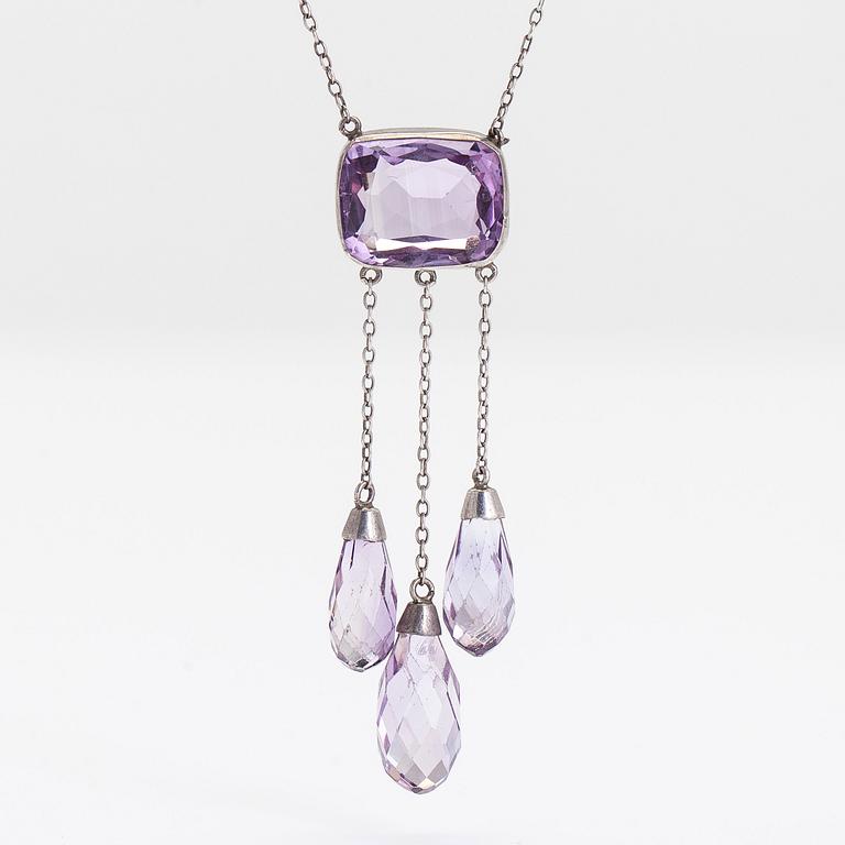 A silver and faceted amethyst necklace.