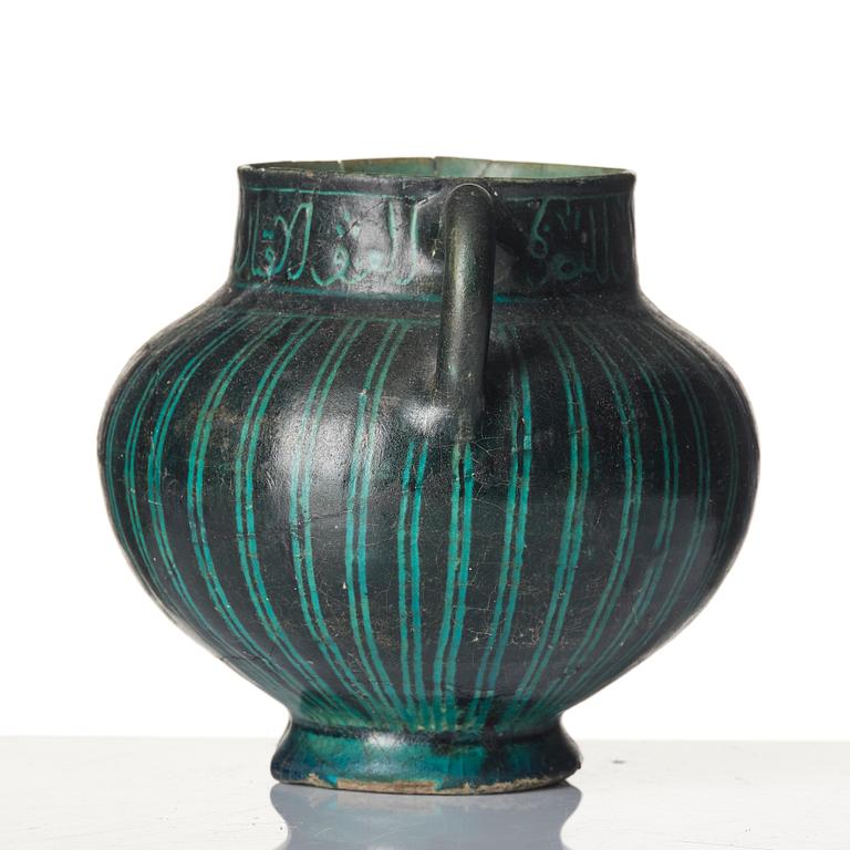 A Kashan Silhouette ware turquoise glazed pottery jug, central Iran, circa 1200.