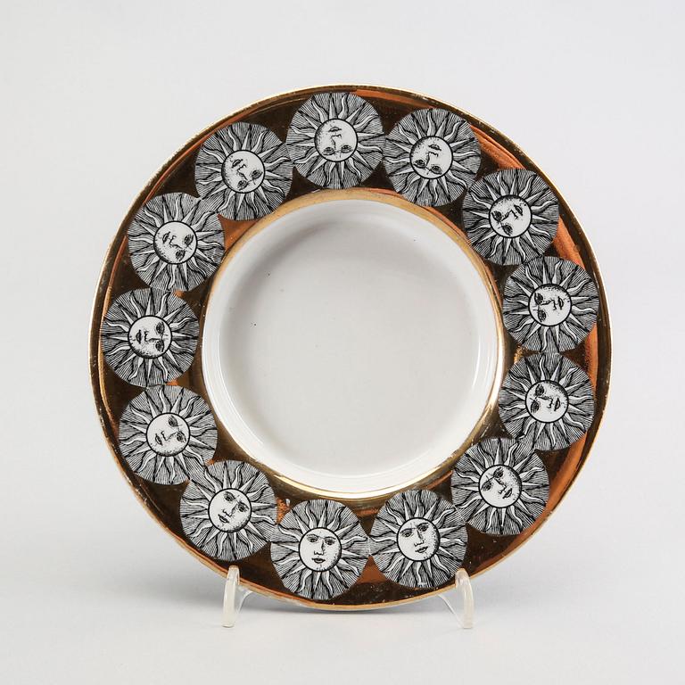 A st of three Piero Fornasetti porcelain plates.