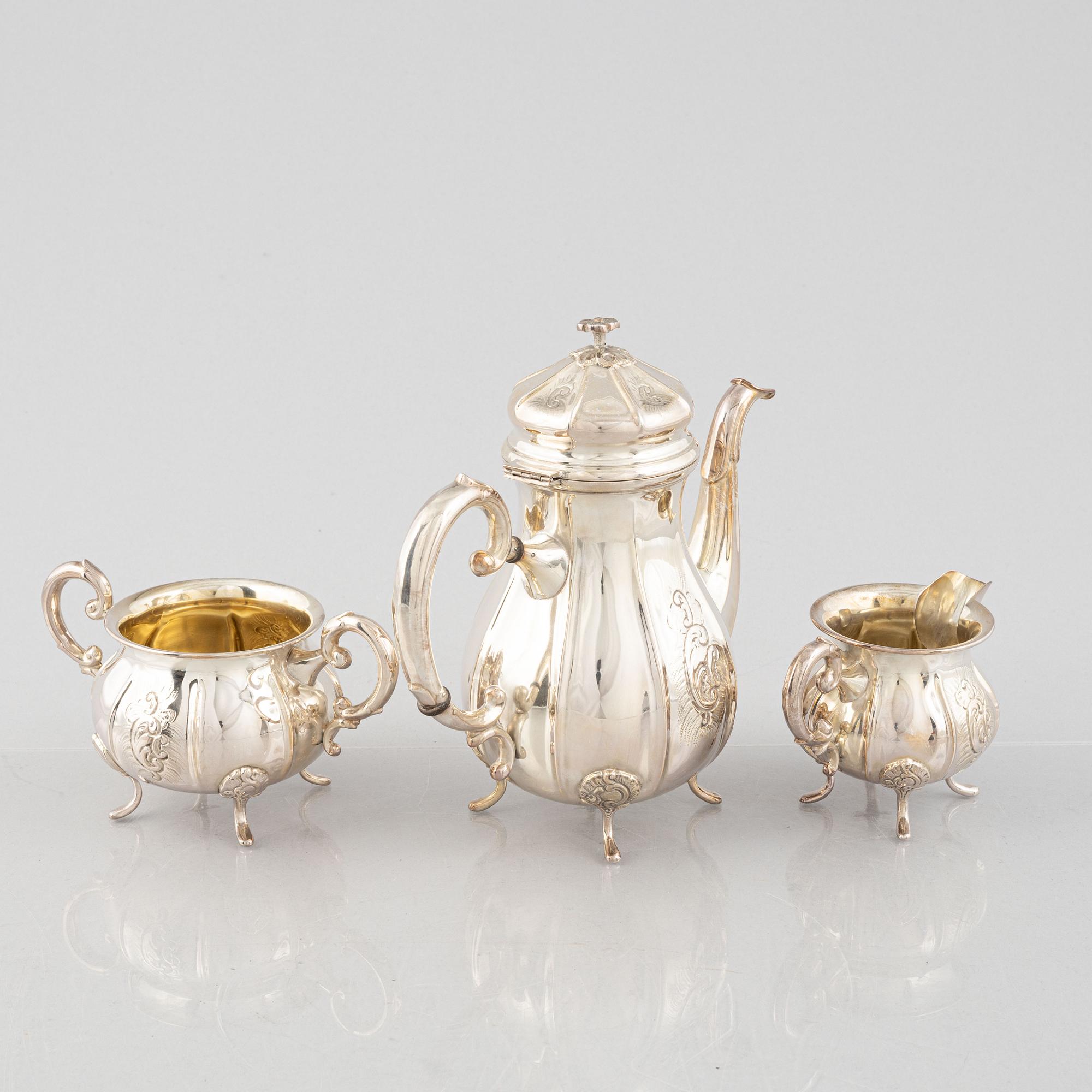 A Swedish Rococo Style Coffee Pot, Creamer and Sugar Bowl, mark of JE Skreij, Falun 1951-55.