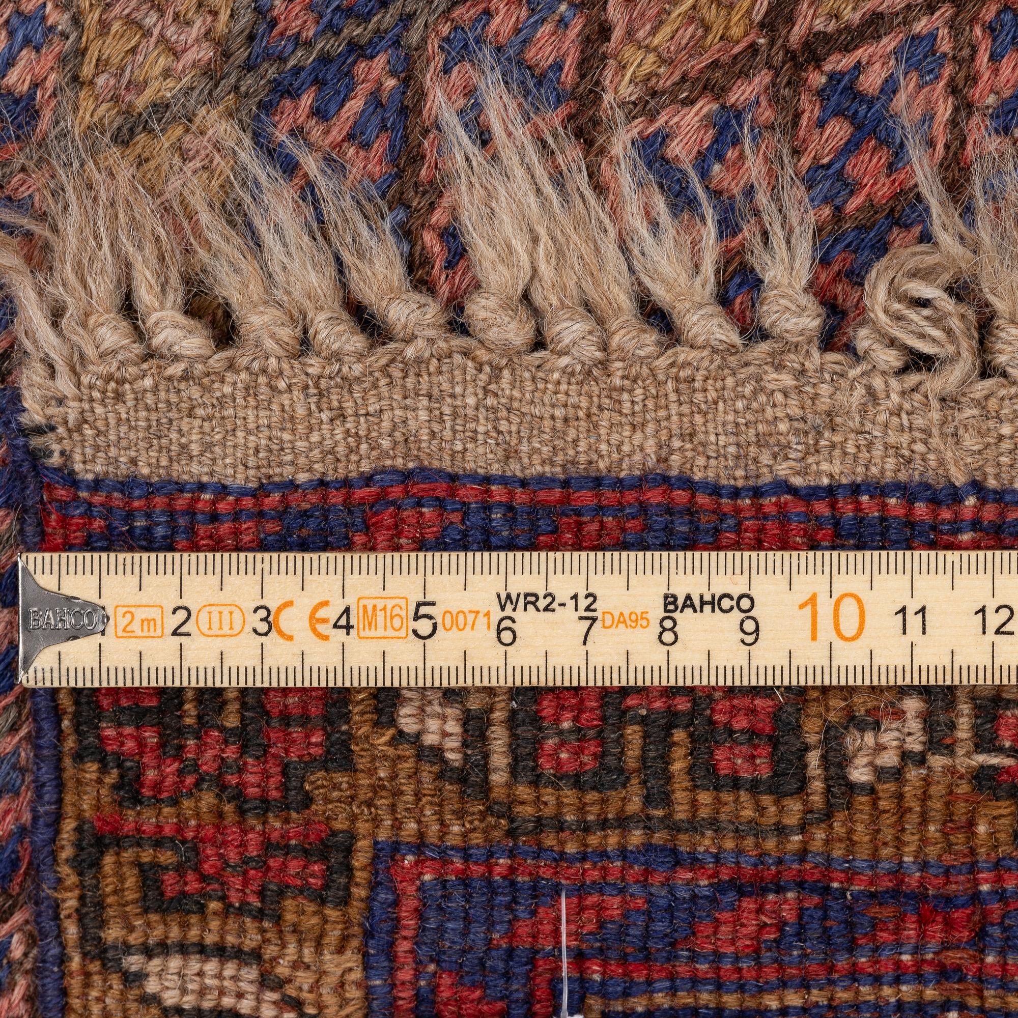 An oriental rug, a. 198 x 130 cm.