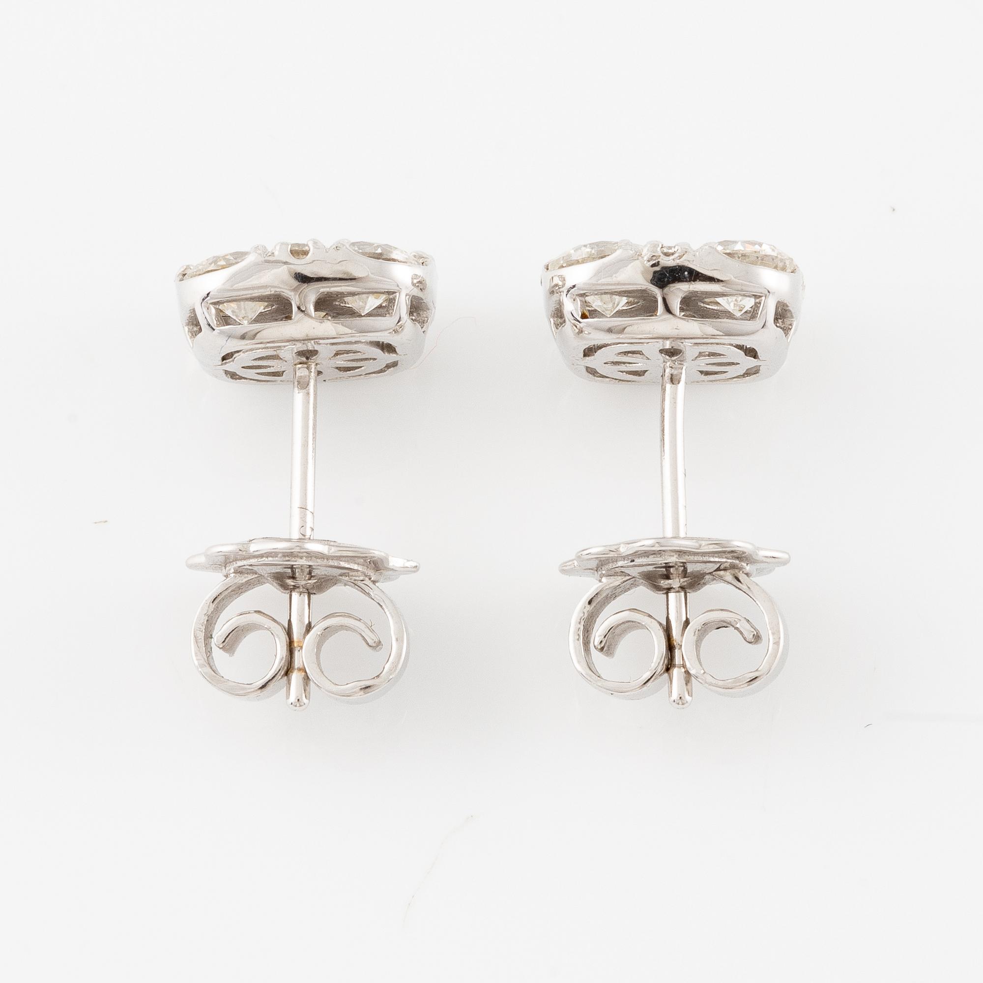 A pair of earrings in 18K white gold set with round brilliant-cut diamonds.