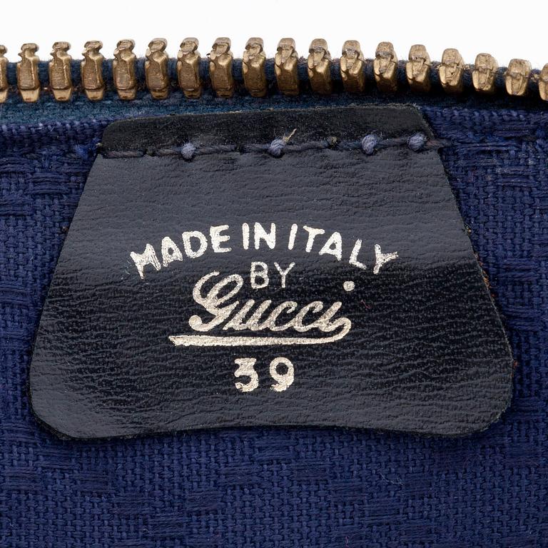 GUCCI, a blue suede and leather weekendbag.