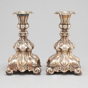 A pair of silver candle sticks.-.
