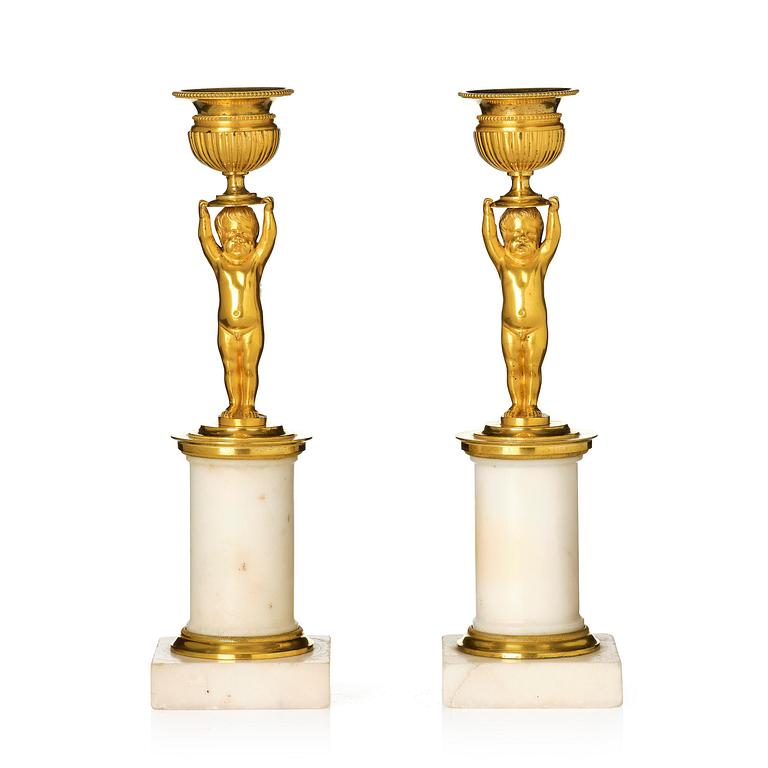 A pair of late Gustavian white marble and ormula candlesticks.