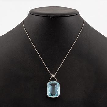 A platinum necklace with a faceted aquamarine and an oval old-cut diamond.