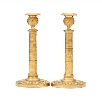 1260. A pair of French Empire early 19th century candlesticks.