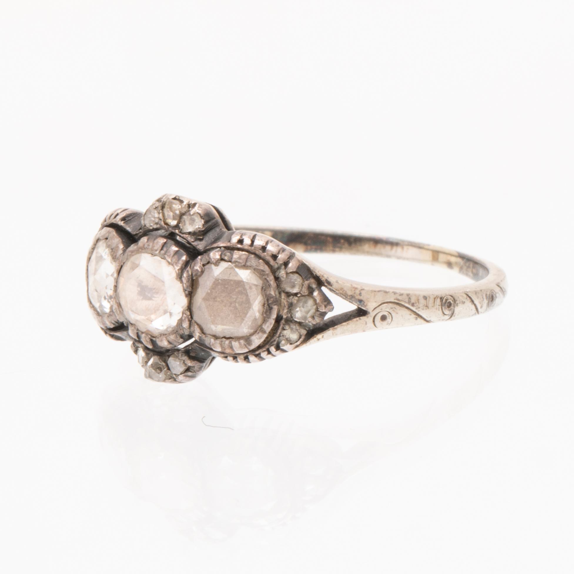 An 18K white gold ring set with rose cut diamonds.