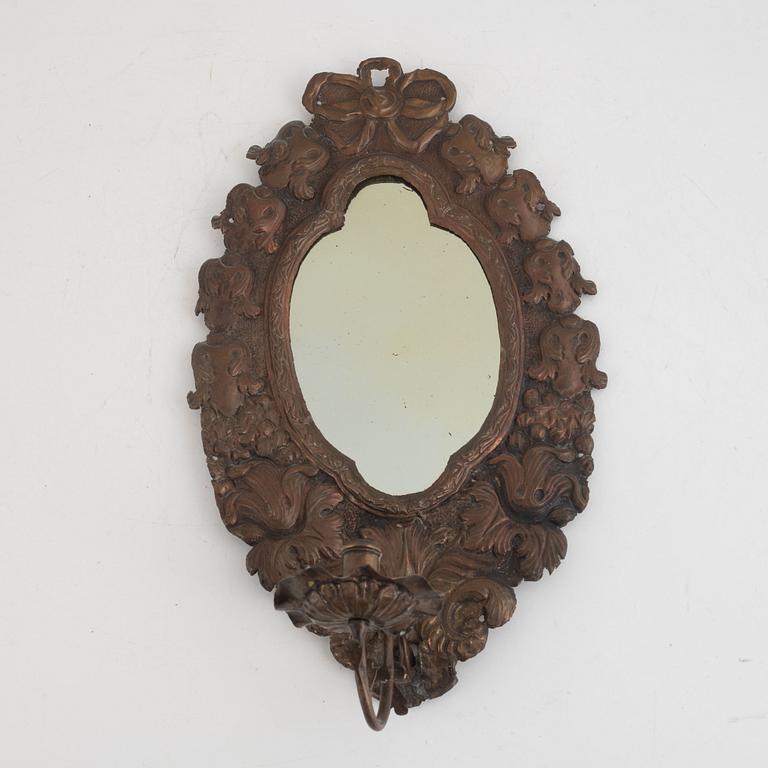 A copper mirror sconce, around 1900.