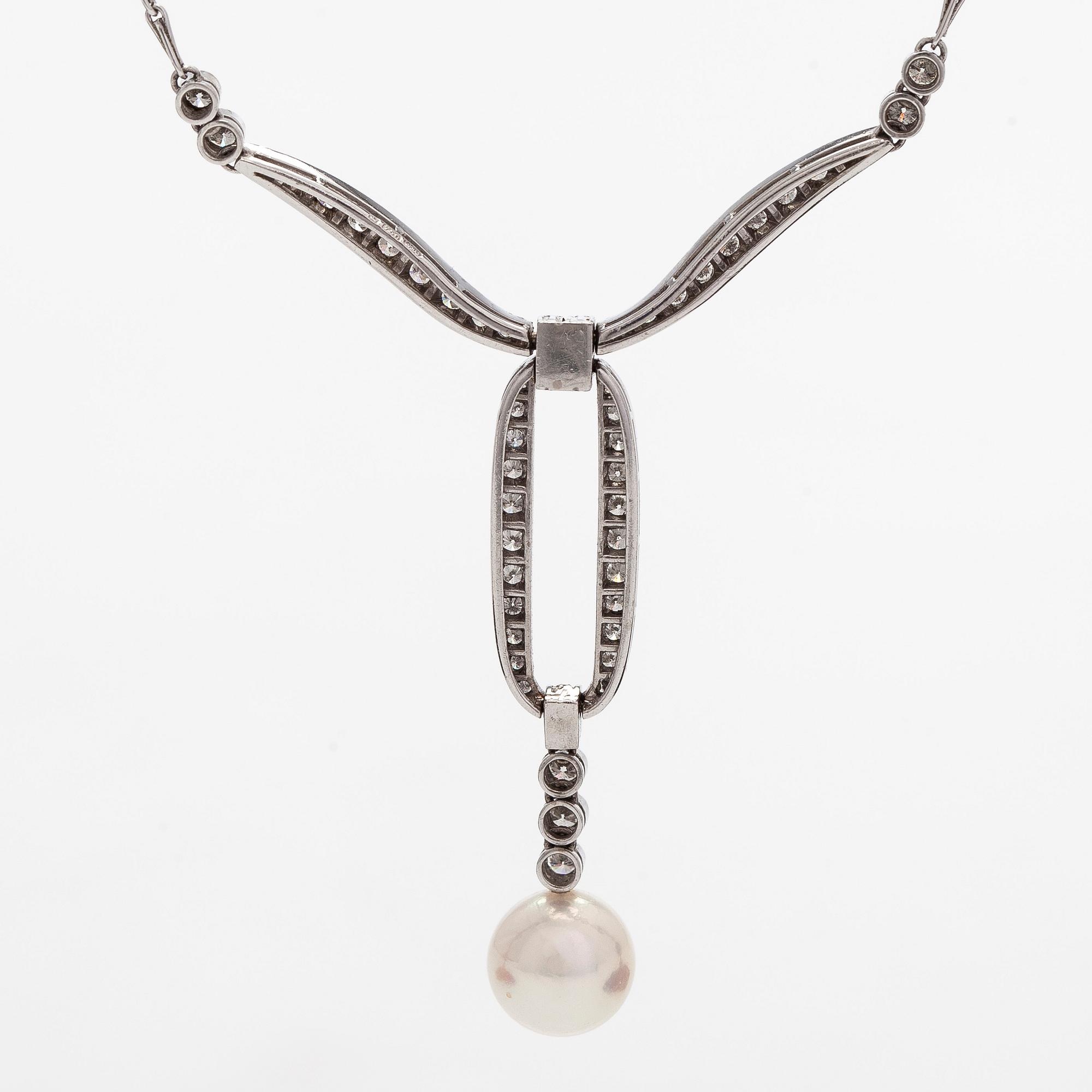 An 18K white gold necklace with brilliant-cut diamonds and a cultured pearl, England.