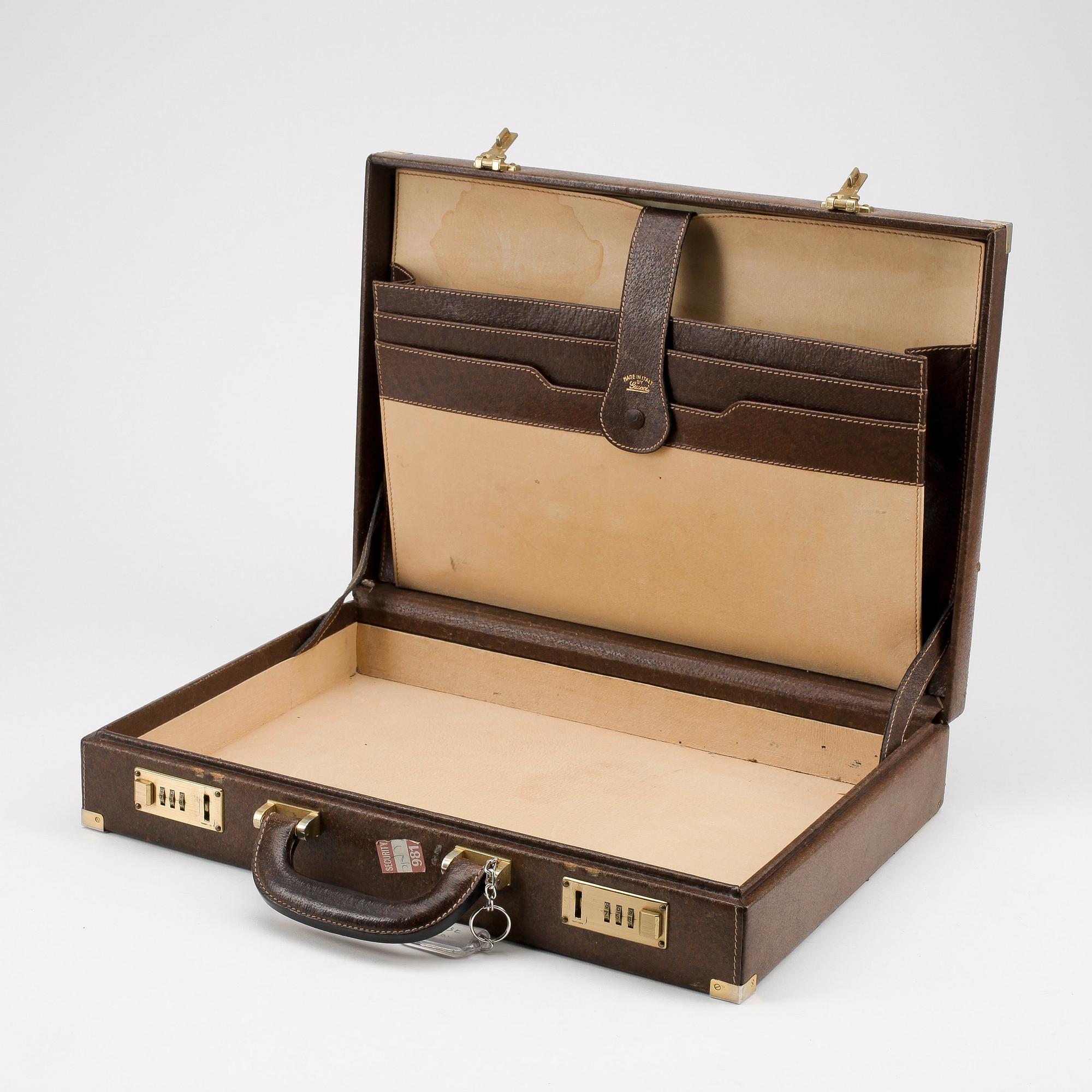 GUCCI, a brown leather briefcase.