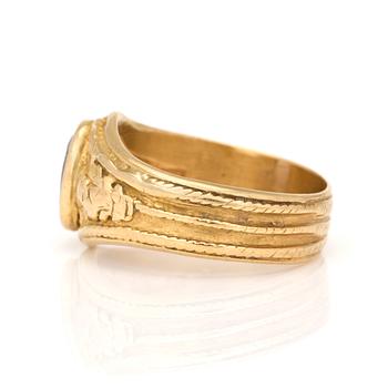 A ring with oval, mixed-cut amethyst.