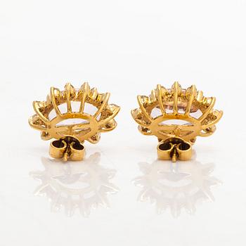 A pair of 14K gold earrings with faceted morganites and brilliant-cut diamonds.