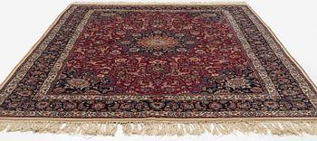 A semi-antique Mashad carpet, signed Saber, c. 401 x 300 cm.