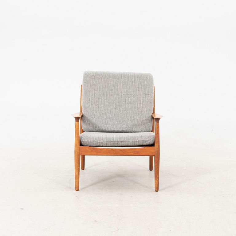 A Grete Jalk teak armchair and sofa from Glostrup Denmark, 1960s, marked.