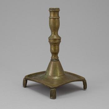 A 17th century bronze candlestick.