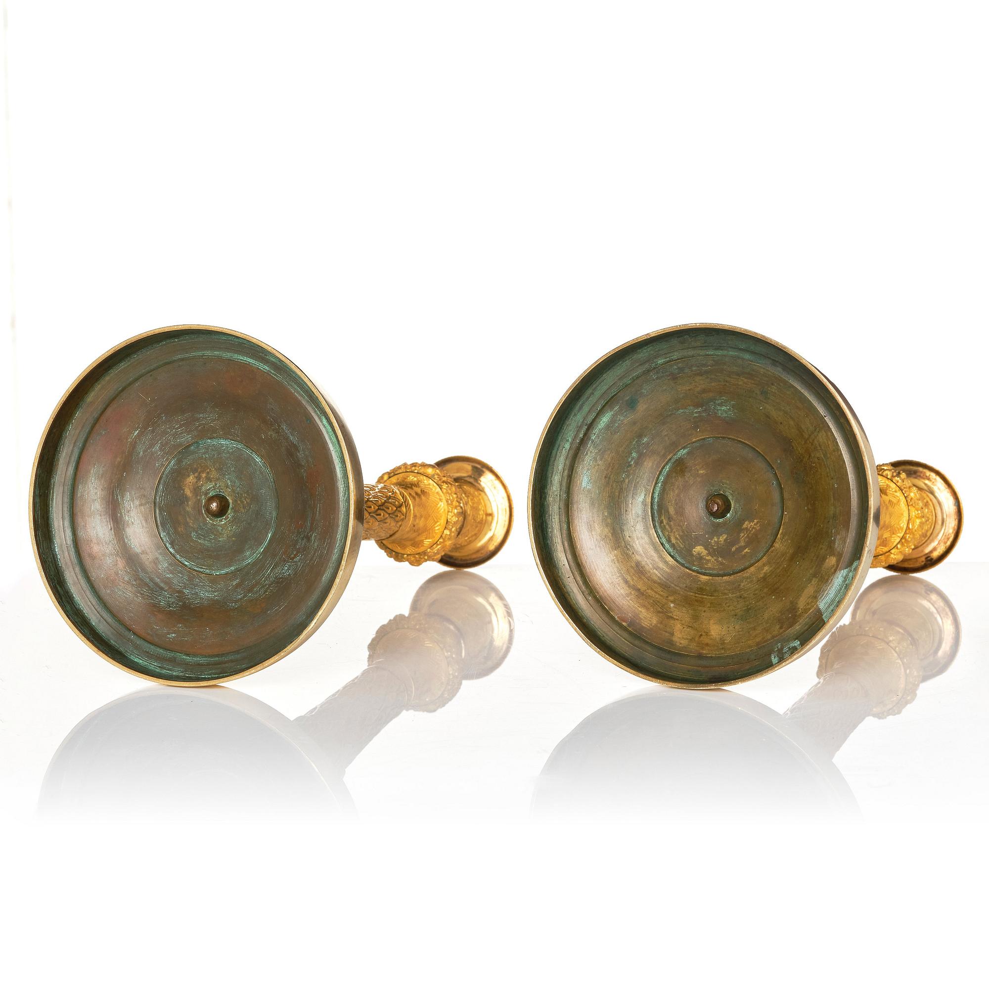 A pair of French Empire candlesticks.