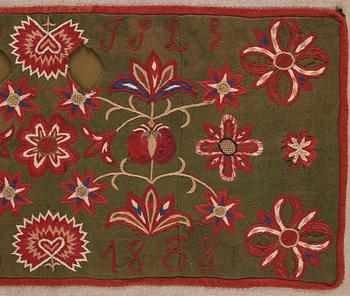 An embroidered carriage cushion, ca 51 x 113 cm (with mounting 61 x 122 cm) signed and dated END JPLG ANO 1838, Scania.