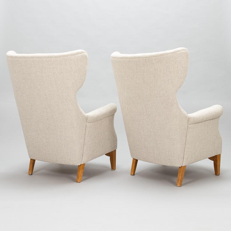 A 1950's pair of 'Inkeri' armchairs manufactured by Asko Finland after a Danish model.