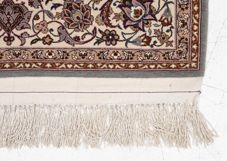 A semi-antique Isfahan rug, central Persia, signed Ghaffarian, c. 180 x 112 cm.