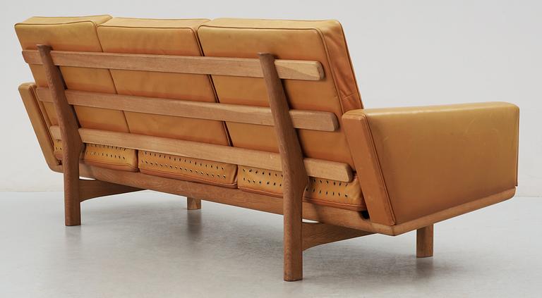 A Hans J Wegner oak and brown leather sofa,