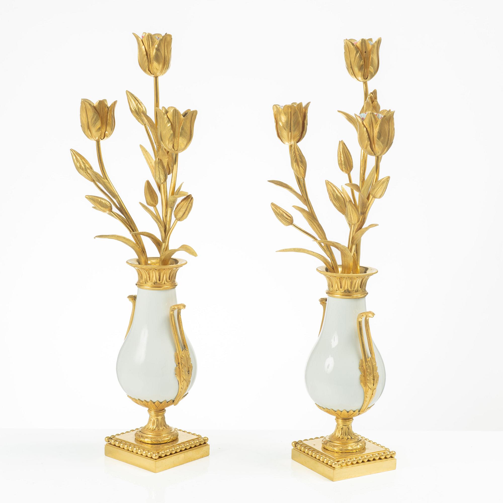A pair of three light porcelain and gilt bronze three-branch Louis XV-style candelabra, mid 19th century.