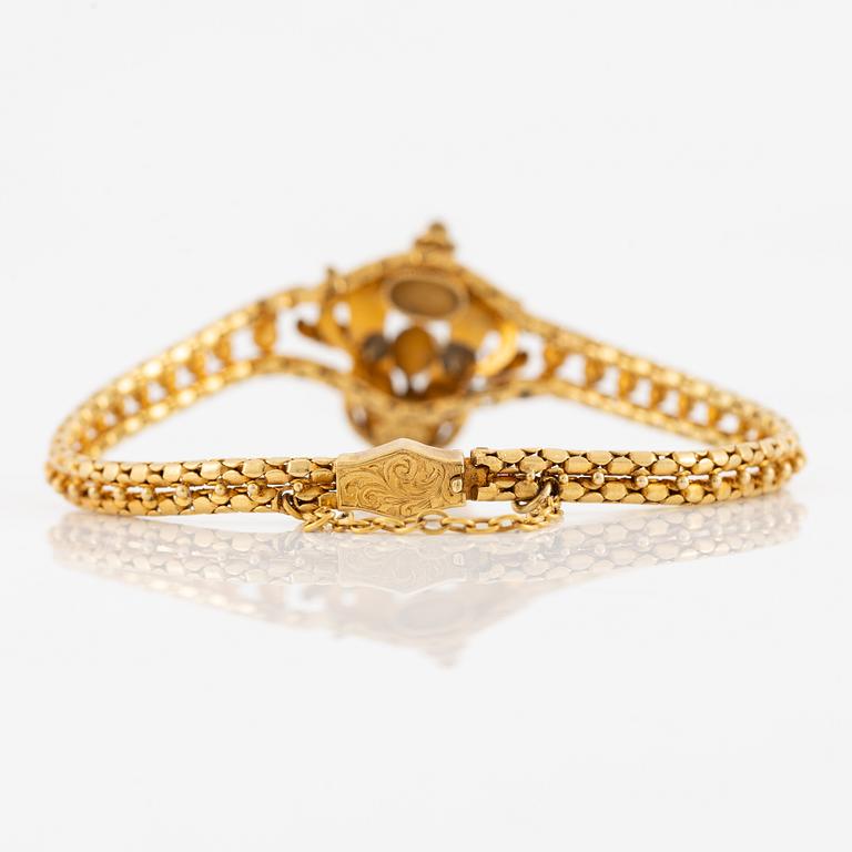 Bracelet, gilded metal with paste stones and enamel.
