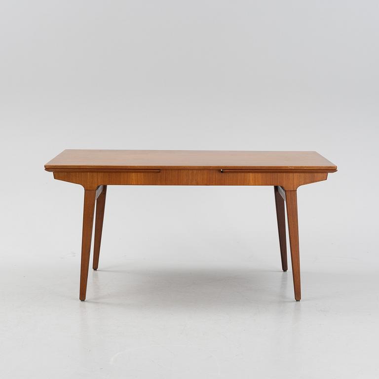 A 1960s teak veneer dining table.