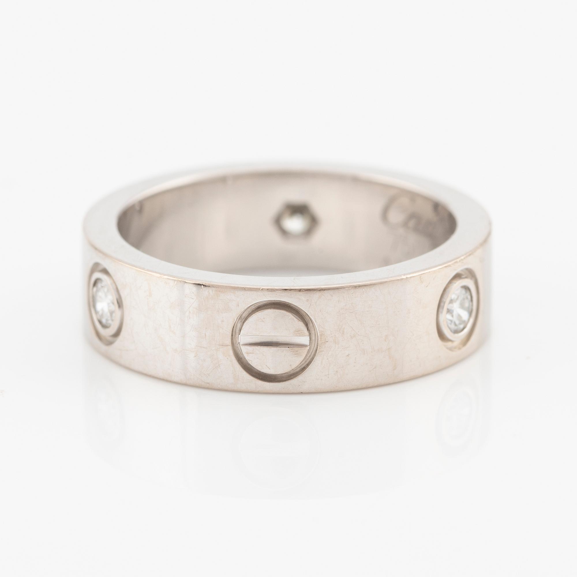 Cartier "Love" ring in 18K white gold with three round brilliant-cut diamonds.