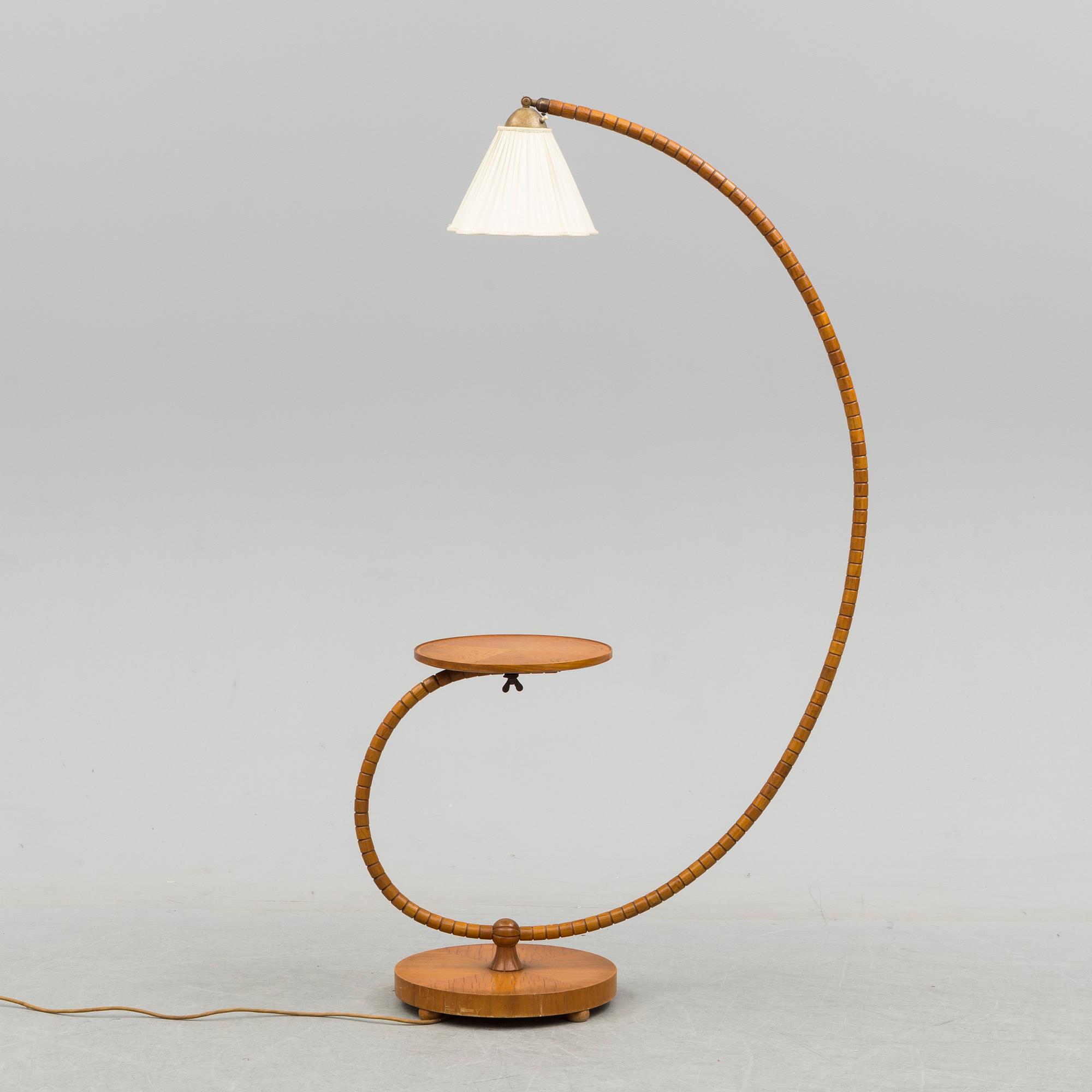 A first half of the 20th century floor lamp with table.