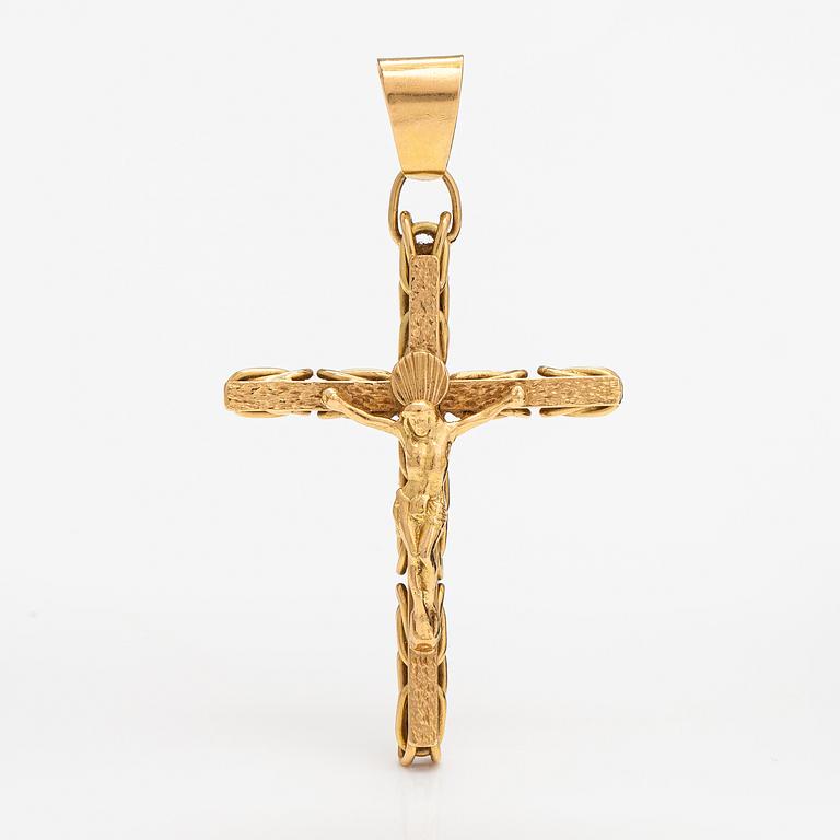 An 18K gold cross pendant.