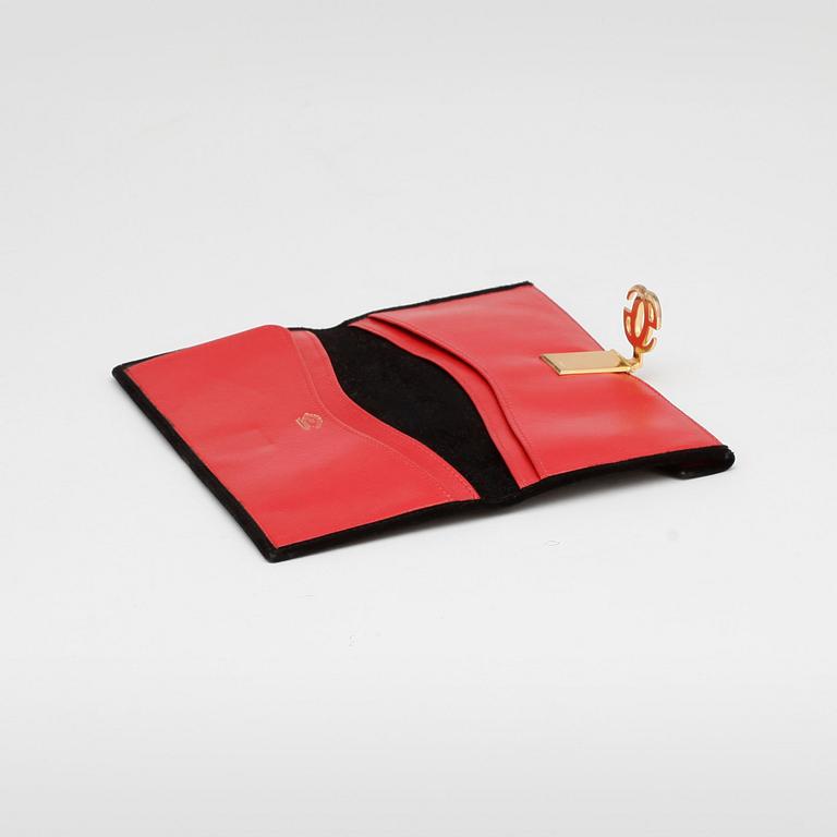 GUCCI, a black suede wallet with red leather lining.