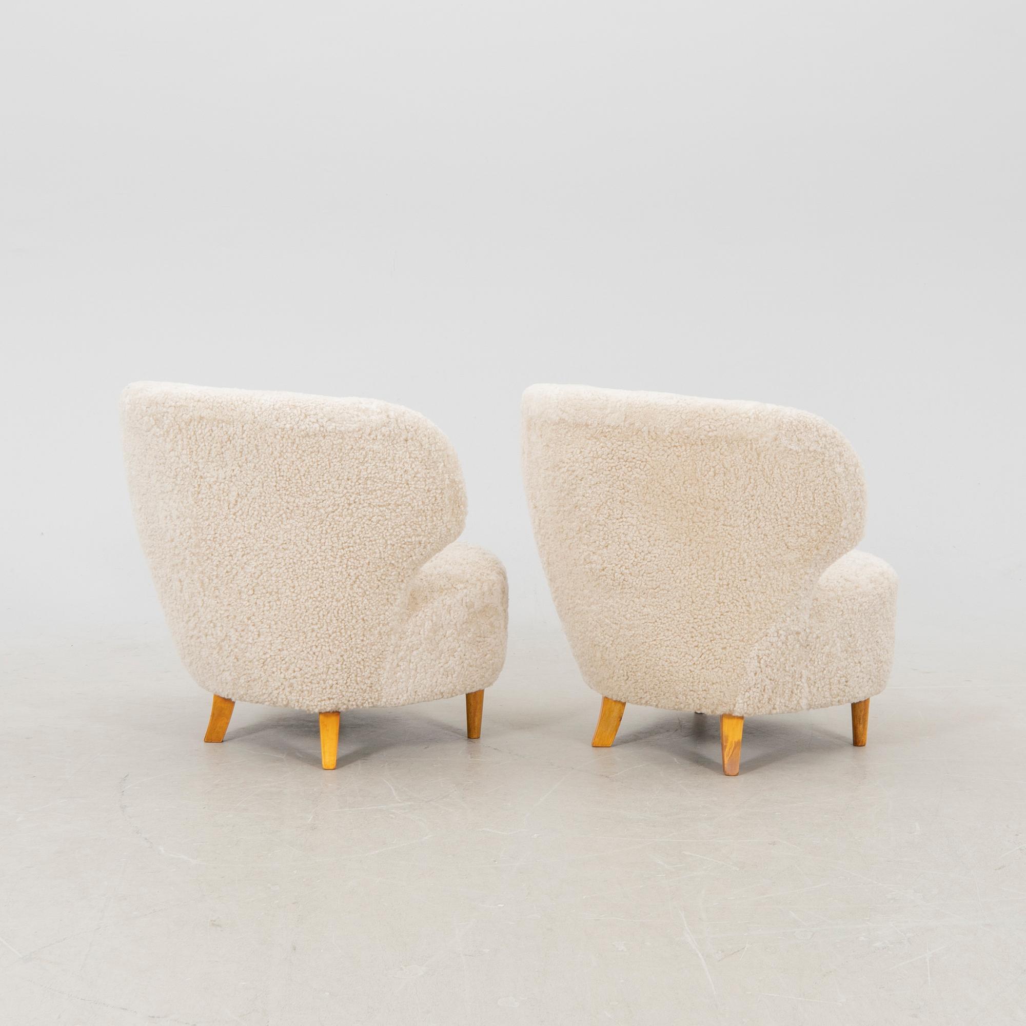 A pair of Scandinavian Modern 1940s cheepskin armchairs.