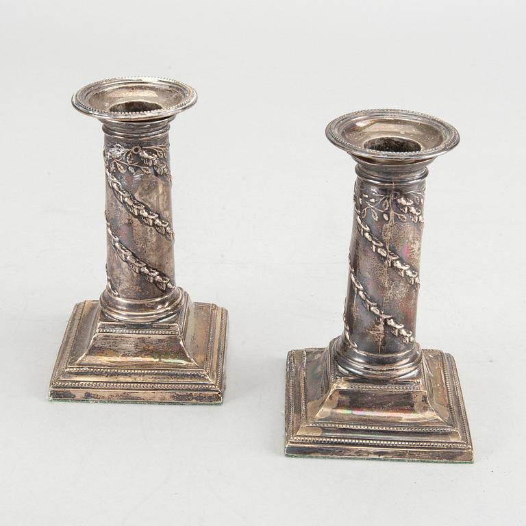 HAWKSWORTH, EYRE & CO LTD a pair of silver candlesticks.