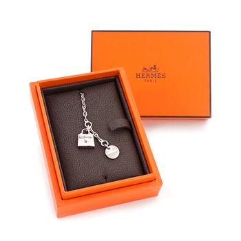 HERMÉS, a sterling silver braclet with a "Kelly" bag charm.
