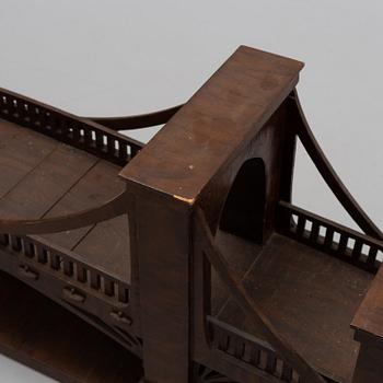 An early 20th century wood model of a bridge.