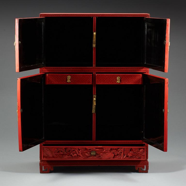 A well carved cinnabar lacquer 'Kang' cabinet, Qing dynasty, 18th century.