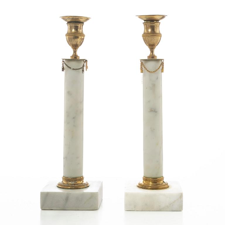 A pair of late Gustavian gilt brass and marble candlesticks, circa 1800.