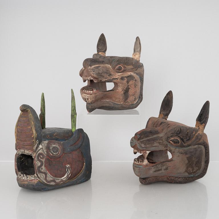 Four Tibetan/South East Asian wooden decorations, 20th century.