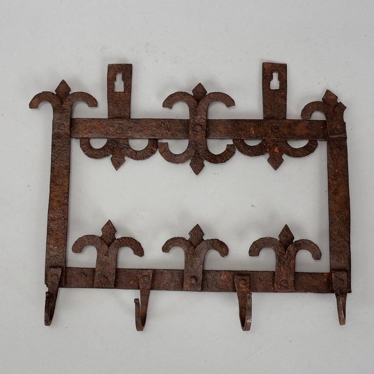 An 18th century iron wall hanger.