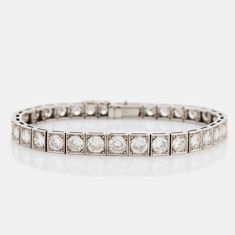 A platinum bracelet set with round brilliant-cut diamonds.