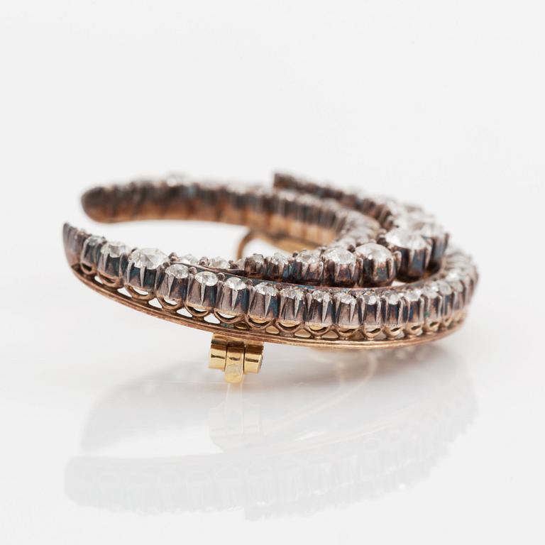 A crescent moon brooch in silver and gold set with old- and rose-cut diamonds.