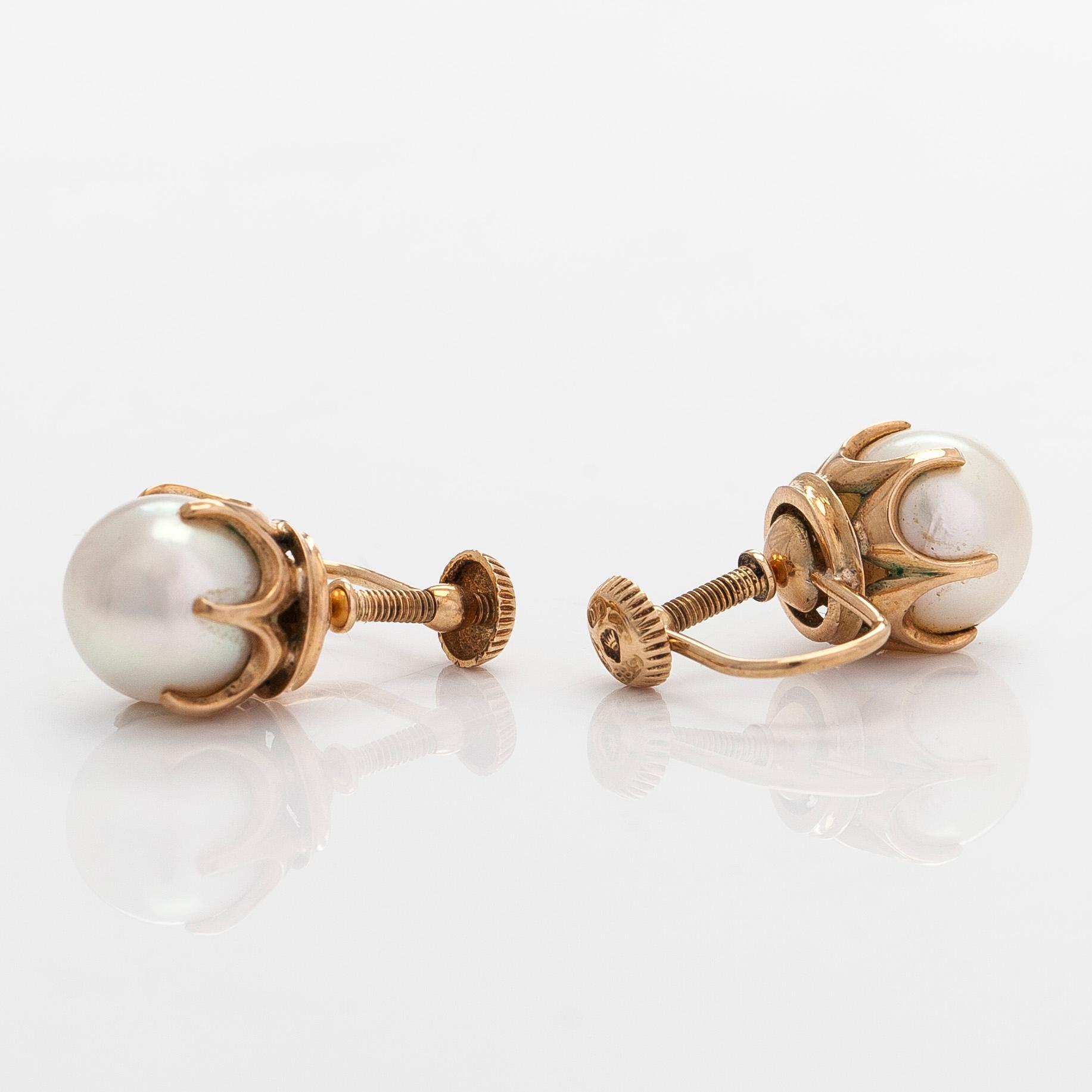A pair of 14K gold earrings with cultured pearls.