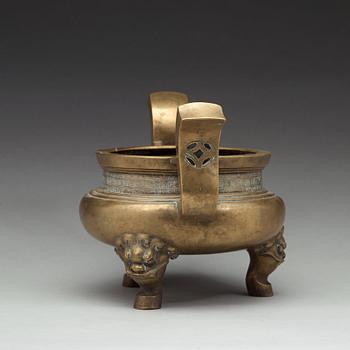 A large brass tripod censer, Qing dynasty (1644-1912).